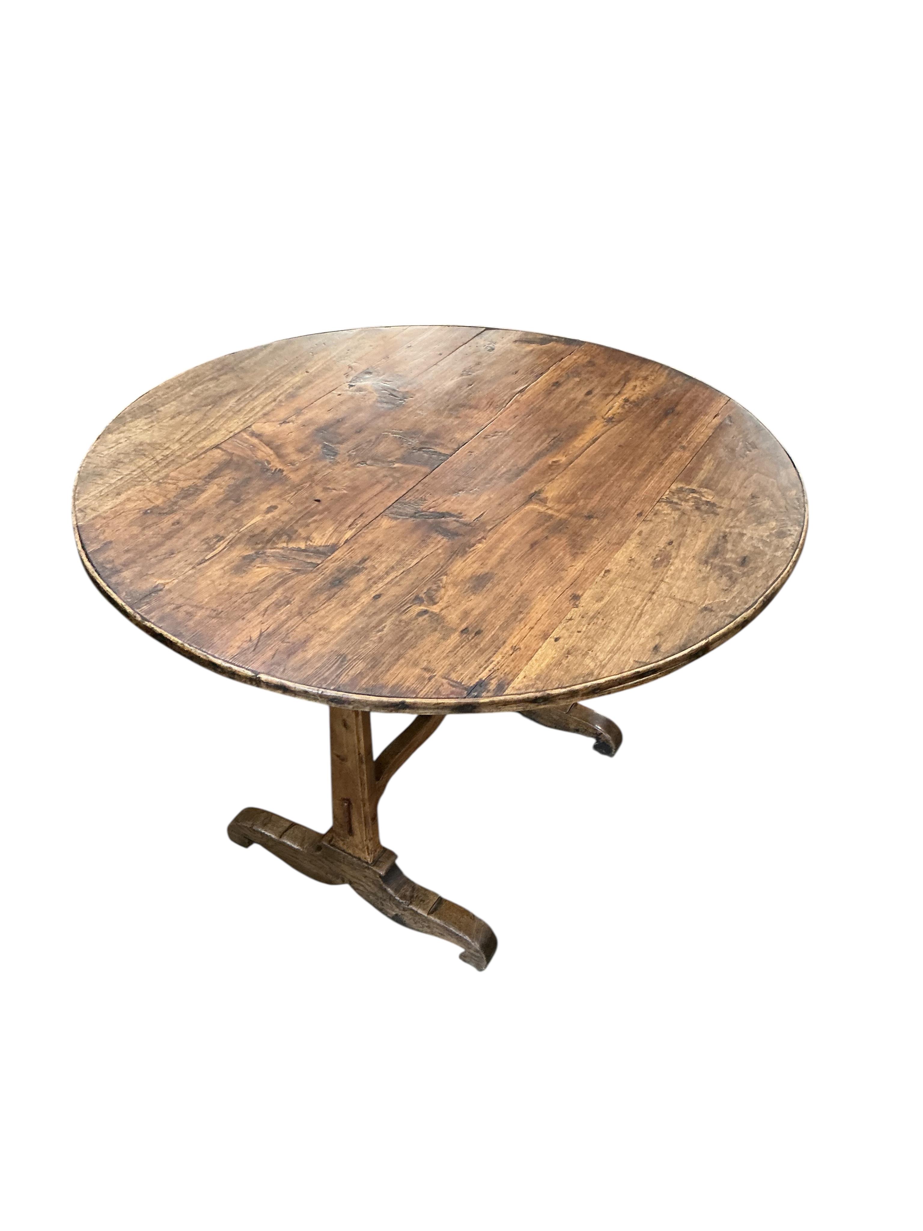 A 19th century French fruitwood wine tasting table, diameter 100cm, height 67cm